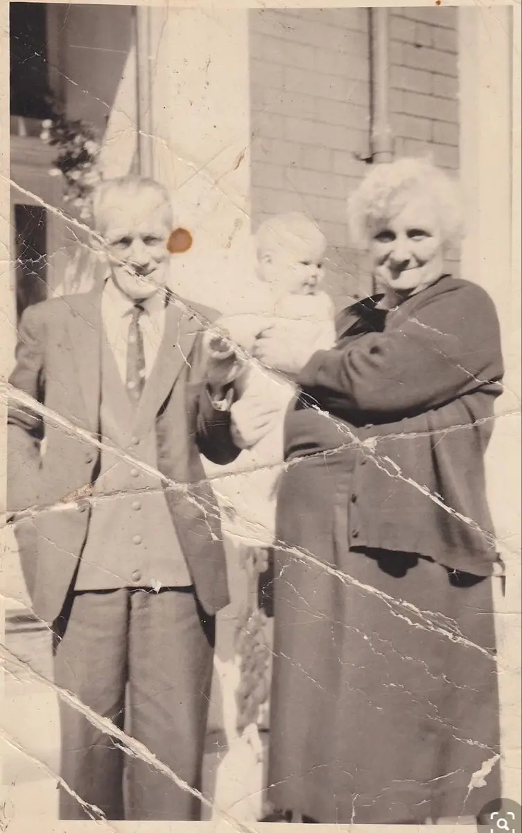 Scratched historical photo of elderly couple restored using advanced old photo restoration service