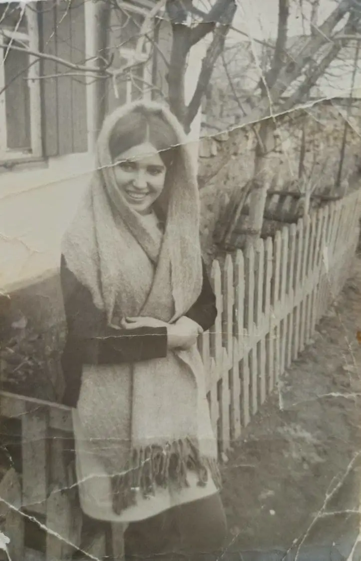 Faded old photo of smiling girl restored with professional photo restoration technology