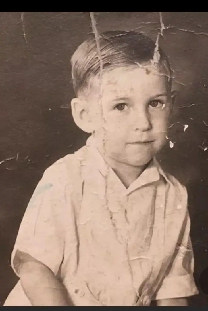 Old scratched photo of boy repaired using advanced photo scratch removal service