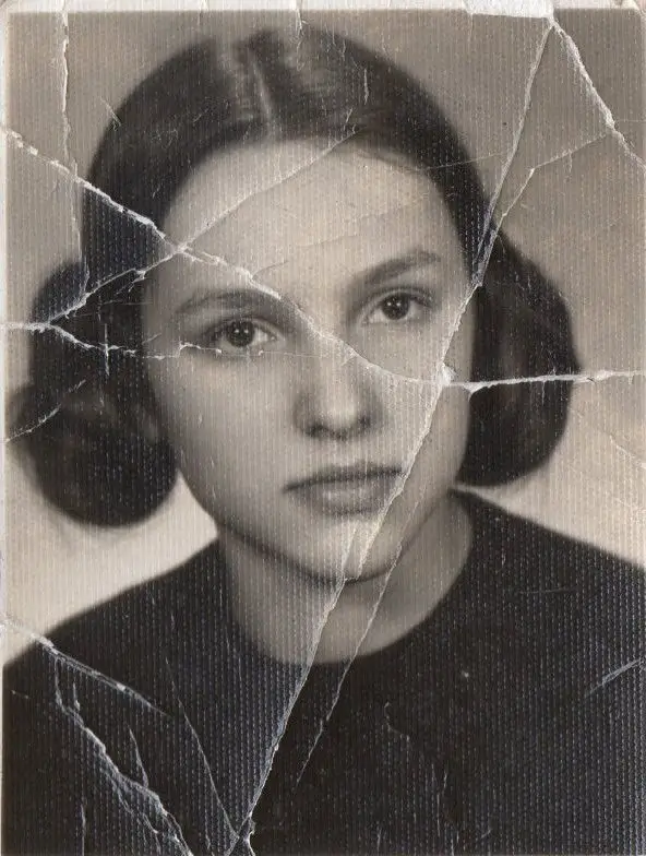 Vintage girl portrait with scratches beautifully repaired through AI scratch removal