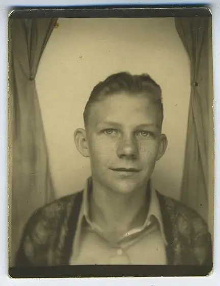 Black and white vintage photo of blond man colorized using AI photo colorization technology